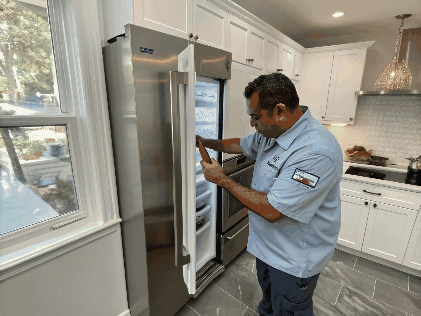 Professional technician inspecting a modern stainless steel kitchen appliance in Lawrenceville Georgia